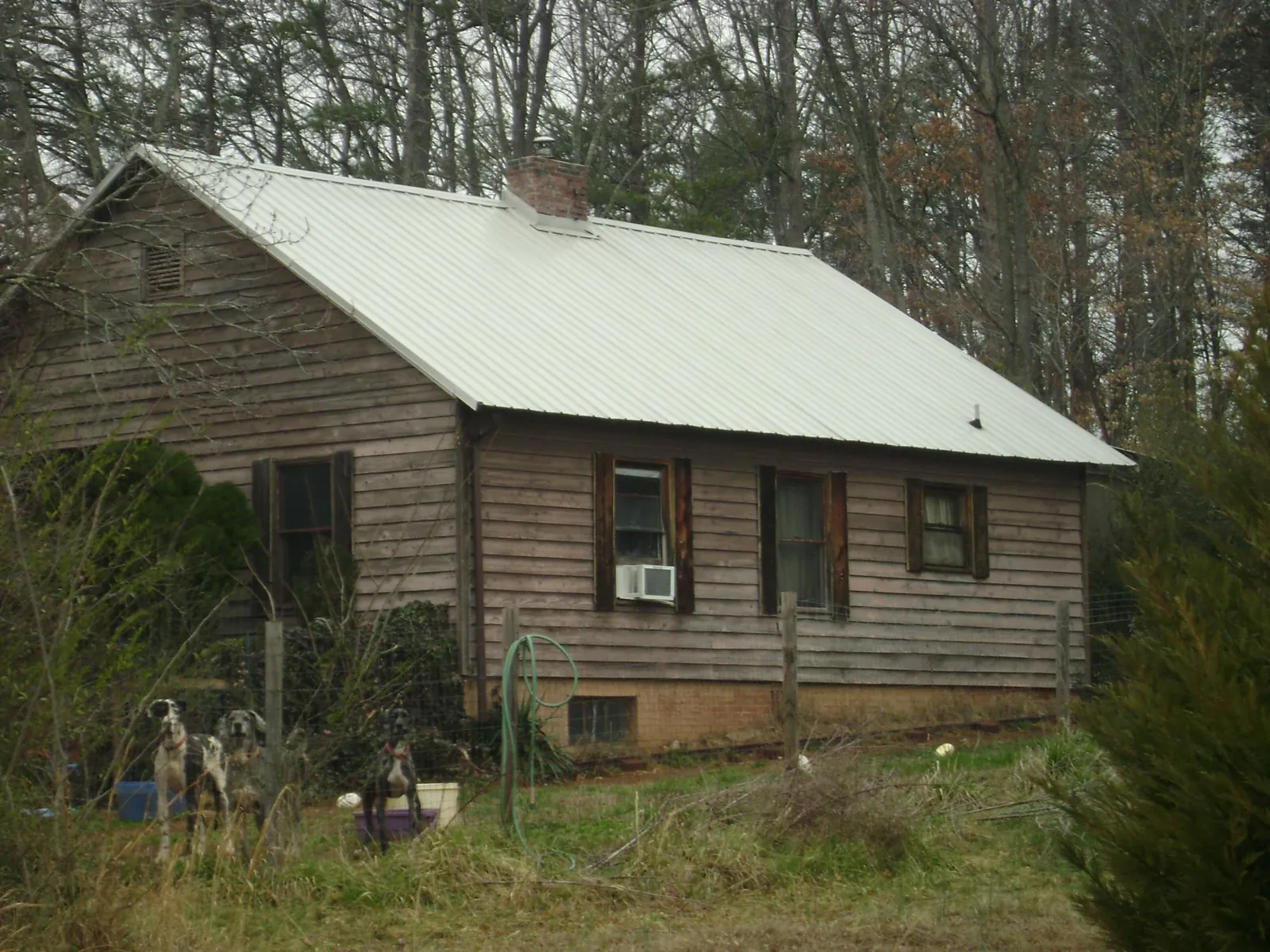 White metal roof on an old wood sided farmhouse, from a Metal Roof Installation job in Lunenburg
